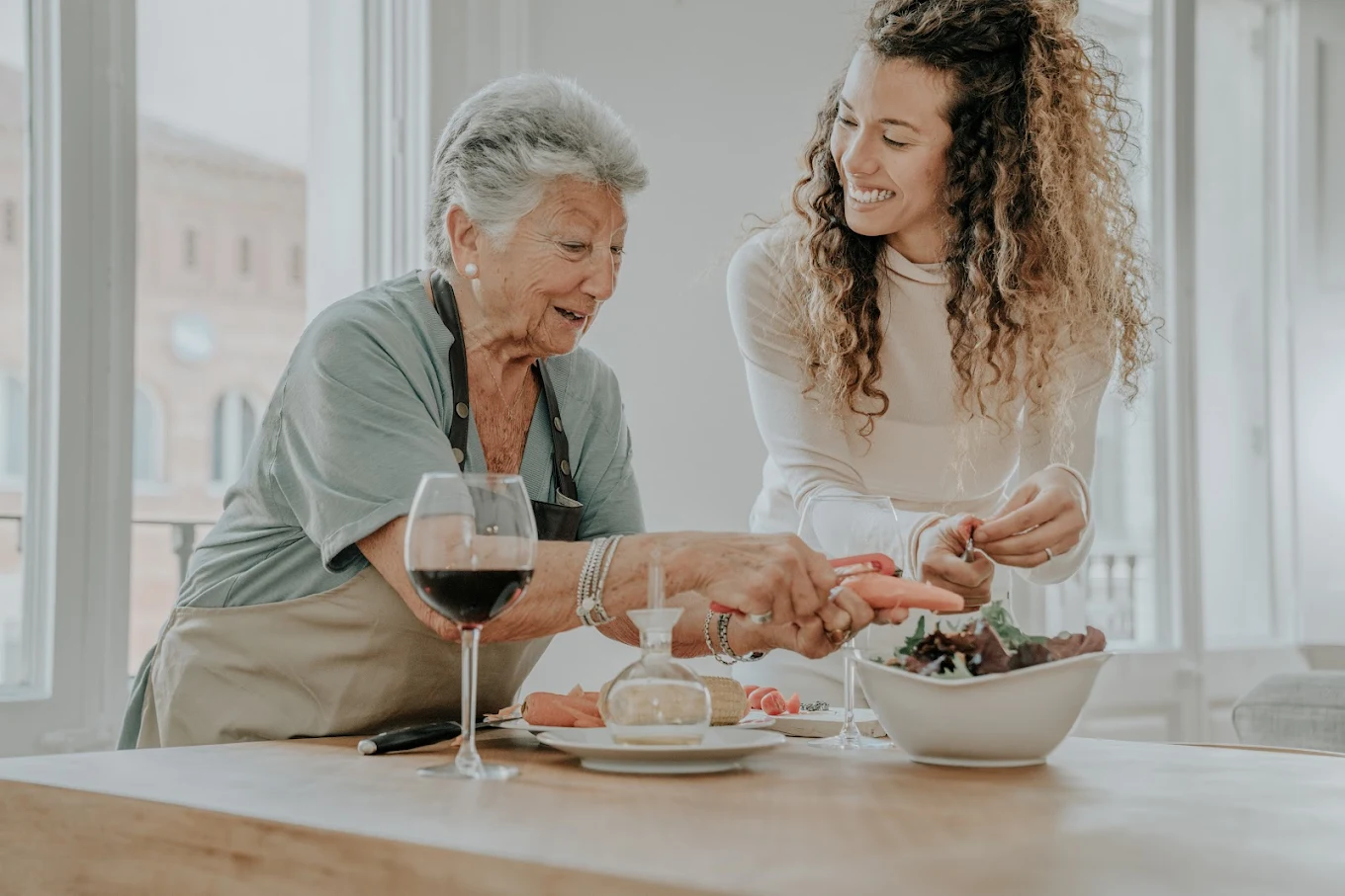 A caregiver and her client sharing a warm, connected moment at home